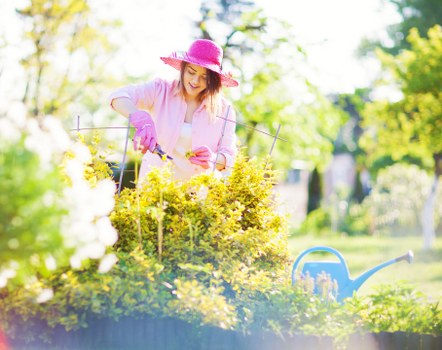 Operative wearing PPE while using gardening equipment
